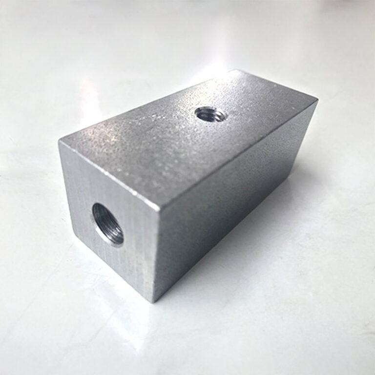 Compact block part with bores on three sides